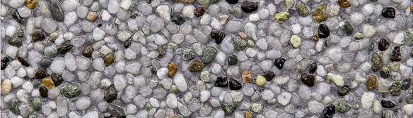 This is a close-up image showing a variety of small, multicolored rocks and pebbles densely packed together, with a textured, granular appearance.